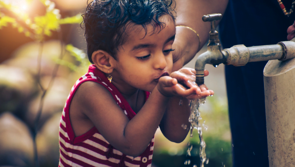 child drinking well water